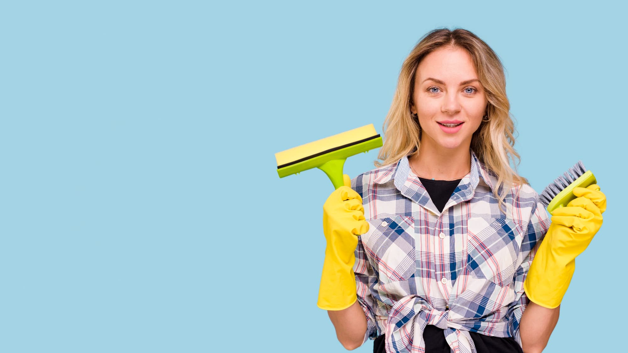 Professional house cleaner from RAAZ Cleaning Services wearing gloves and headphones while wiping and disinfecting surfaces in a bright, modern San Diego home. RAAZ provides eco-friendly, detailed residential and commercial cleaning services with flexible scheduling and 100% satisfaction guaranteed across San Diego County.